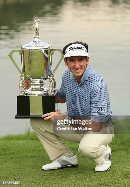 Gonzalo Fernandez-Castano of Spain celebrates with the trophy after winning the playoff on the 18th hole on day five of the Barclays Singapore Open...