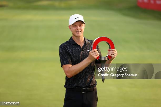 Cam Davis of Australia poses with the trophy after winning on the fifth sudden death playoff hole against Troy Merritt during the final round of the...