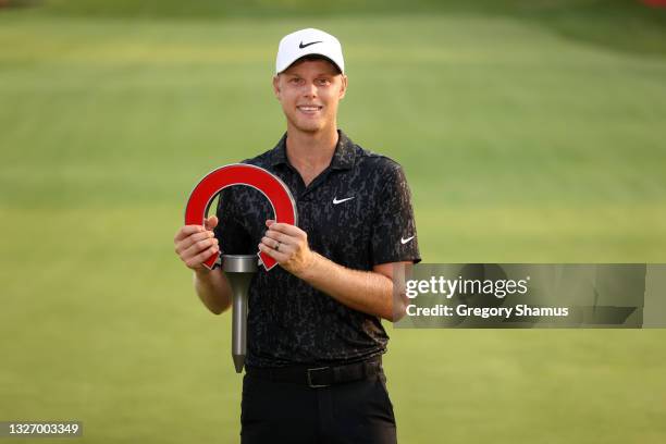 Cam Davis of Australia poses with the trophy after winning on the fifth sudden death playoff hole against Troy Merritt during the final round of the...