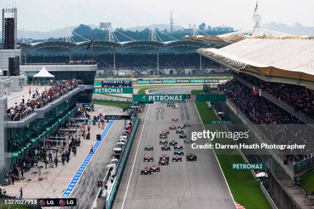 German Red Bull Racing Formula One driver Sebastian Vettel driving his RB7 racing car leads British McLaren driver Lewis Hamilton, McLaren driver...