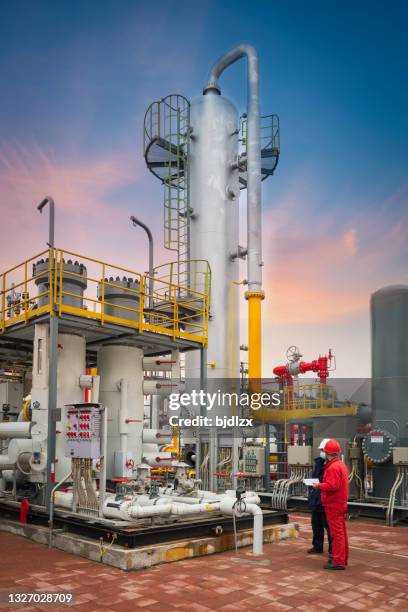 engineers and staff communicate on site in chemical plant - oil and gas industry stockfoto's en -beelden