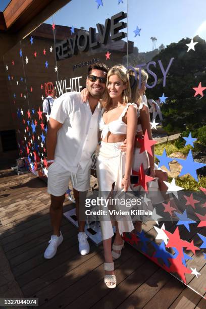 Dylan Barbour and Hannah Godwin attend the 'Red, White and Bootsy' annual July 4th bash, presented by REVOLVE and The h.wood Group on July 04, 2021...