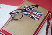 British language textbook and glasses are on table