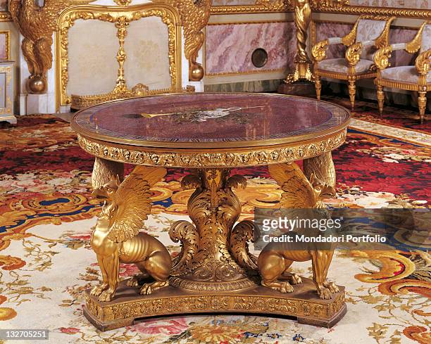 Italy, Tuscany, Florence, Palazzo Pitti, Royal Apartments. Whole artwork view. Table round tea-table griffins fantastic creatures gold decoration...