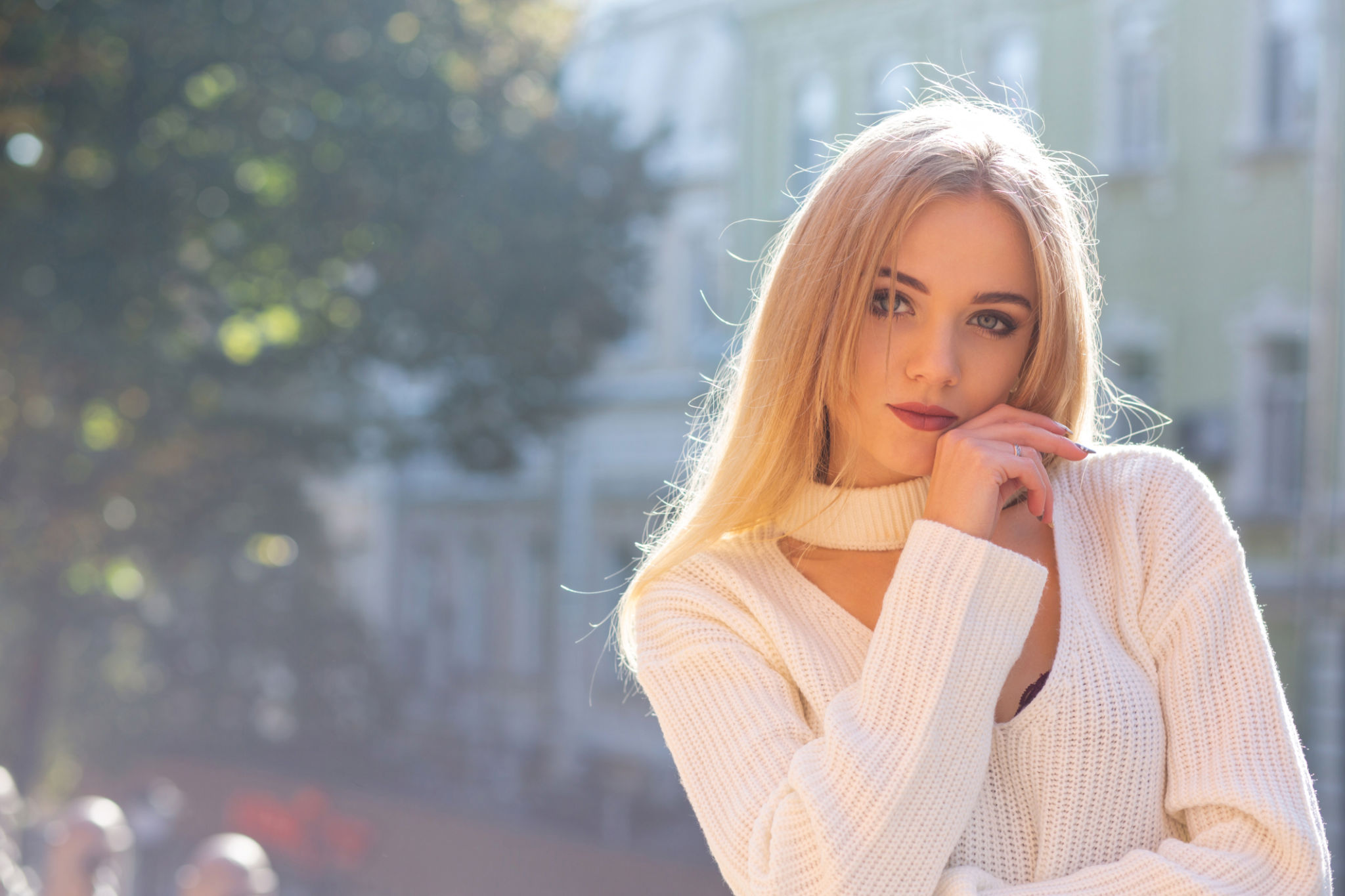 Outdoor portrait of glamorous model wearing stylish outfit posing at the street with natural sun light. Empty space Outdoor portrait of glamorous model wearing stylish outfit posing at the street with natural sun light. Empty space