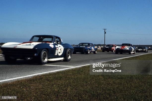 Pair of Chevrolet Corvettes race against a Chevrolet Camaro, Ford Mustang and a Ford GT-40 during the 24 Hours of Daytona at Daytona International...