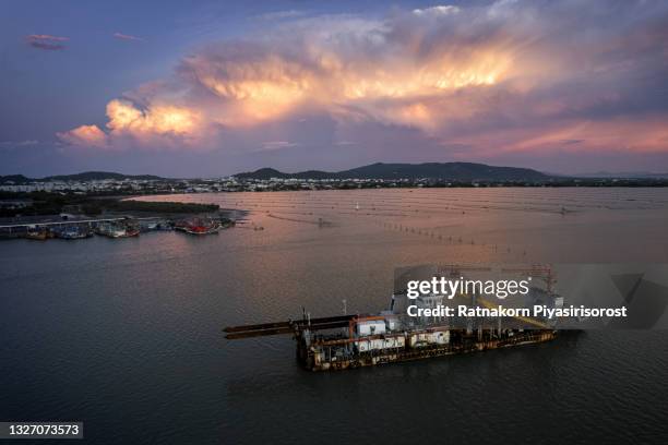 aerial drone scene of sand sucking boat parked at the middle of the river, songkhla, thailand - dredger stock pictures, royalty-free photos & images