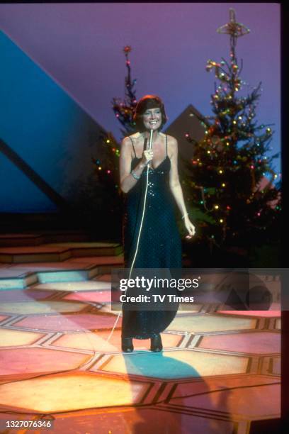 Entertainer Cilla Black performing on stage, circa 1980.