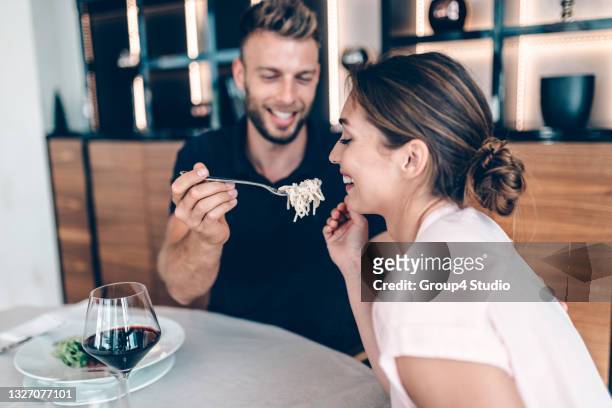 happy couple at hotel restaurant while chef preparing food - young couple dining stock pictures, royalty-free photos & images