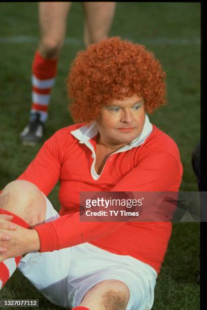 Comedian Benny Hill dressed as a female footballer, circa 1980.