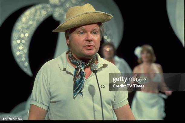 Comedian Benny Hill performing on set, circa 1972.