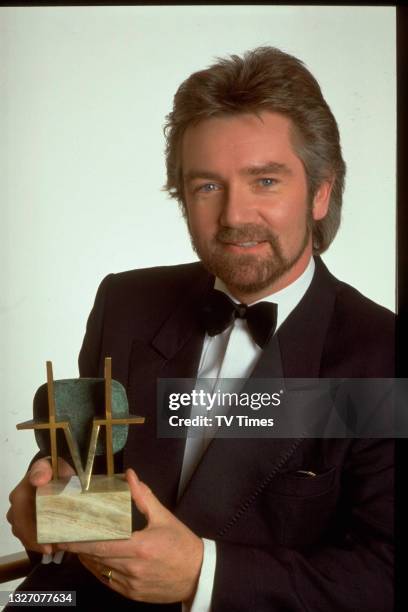 Television presenter Noel Edmonds holding a TV Times Award, circa 1990.