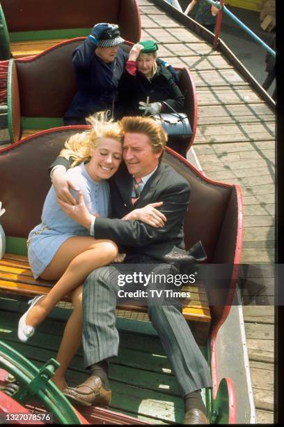 Violet Carson, Margot Bryant, Peter Adamson and Julie Goodyear riding teacups in character as Ena, Minnie, Len and Bet in television soap Coronation...