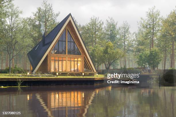 triangular modern lake house at fall - woodland stock pictures, royalty-free photos & images