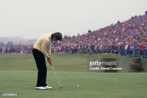 Nick Faldo of Great Britain watches the golf ball to the hole following his putt on the 18th green to win the 116th Open Championship golf tournament...