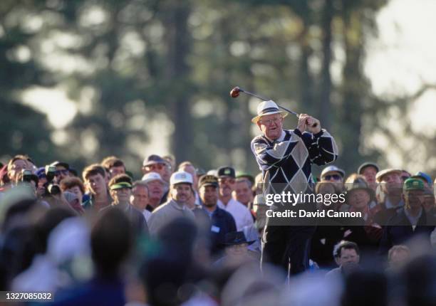 Spectators look on as Byron Nelson of the United States drives off the 1st tee taking the honorary tee shot before the start of the 58th US Masters...