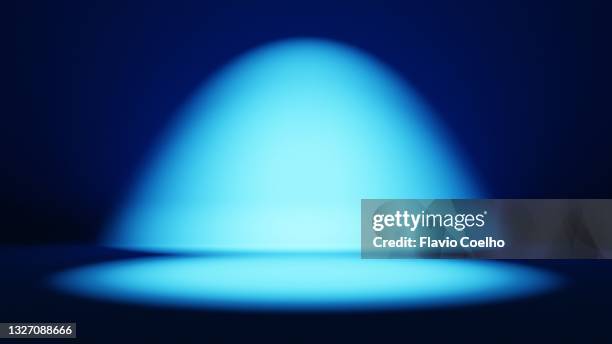 blue spot lit stage background - spotlight film stock pictures, royalty-free photos & images