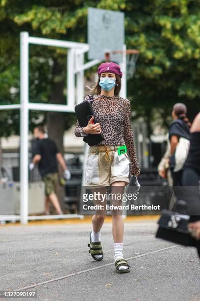 Guest wears a burgundy mesh print pattern beret / hat from Kandol, a black tank-top, a transparent brown and black leopard print pattern long sleeves...