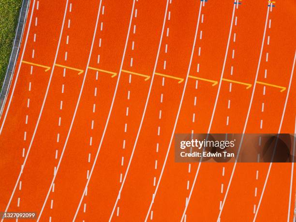 directly above drone point of view starting line all weather track and field stadium in the morning - all weather running track stock pictures, royalty-free photos & images