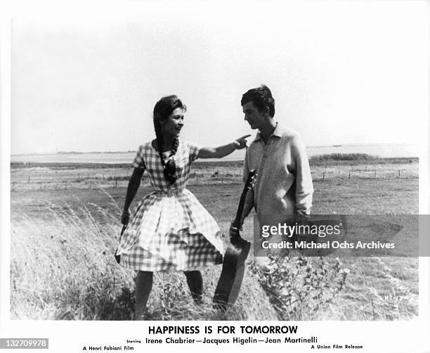 Irene Chabrier walking in the field with Jacques Higelin in a scene from the film 'Happiness Is For Tomorrow', 1961.