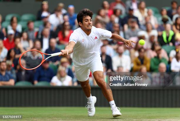 Cristian Garin of Chile stretches to play a forehand in his Men's Singles Fourth Round match against Novak Djokovic of Serbia during Day Seven of The...
