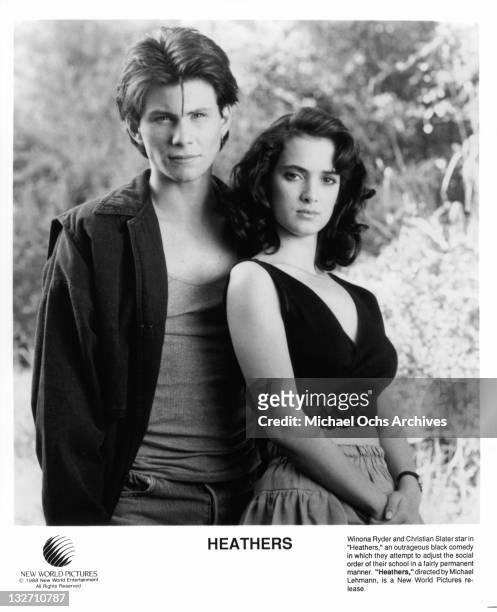 Christian Slater and Winona Ryder standing together in a scene from the film 'Heathers', 1988.
