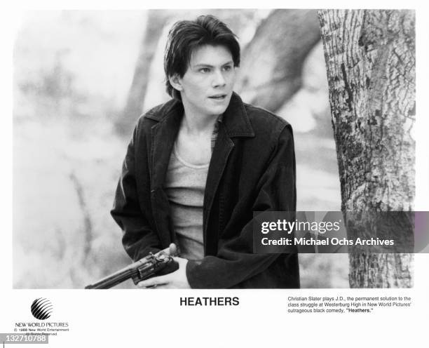 Christian Slater holding gun in a scene from the film 'Heathers', 1988.