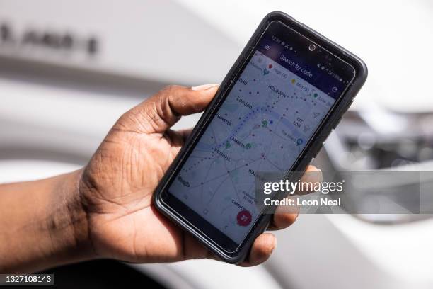 Tier technician shows the GPS phone app that alerts him to the location of faulty units on July 05, 2021 in London, England. Tier Mobility is one of...