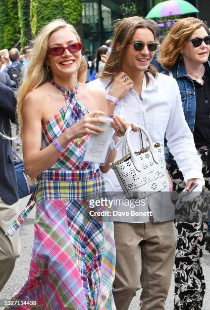 Clara Paget and Oscar Tuttiett attend day 8 of Wimbledon 2021 at All England Lawn Tennis and Croquet Club on July 05, 2021 in London, England.