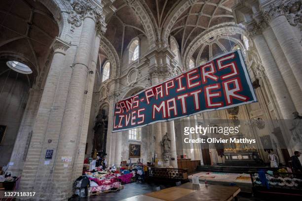 Migrant workers without papers rest during a hunger strike in the Church of St. John the Baptist at the Béguinage on July 5, 2021 in Brussels,...