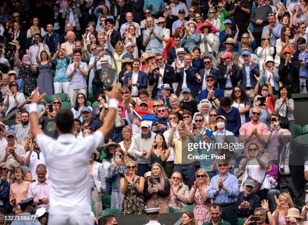 Novak Djokovic of Serbia celebrates victory to the crowd after winning his Men's Singles Fourth Round match against Cristian Garin of Chile during...