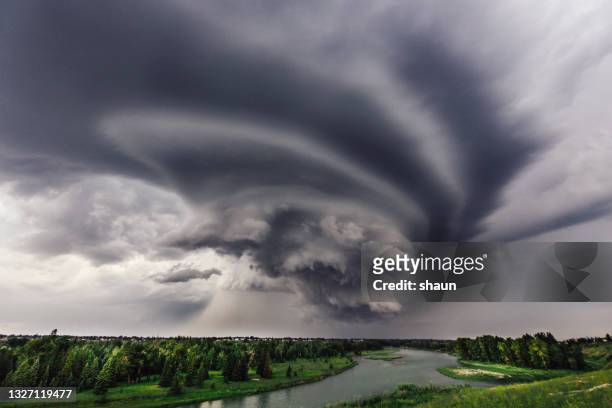 incoming storm over the bow river in calgary - extreme weather stock pictures, royalty-free photos & images