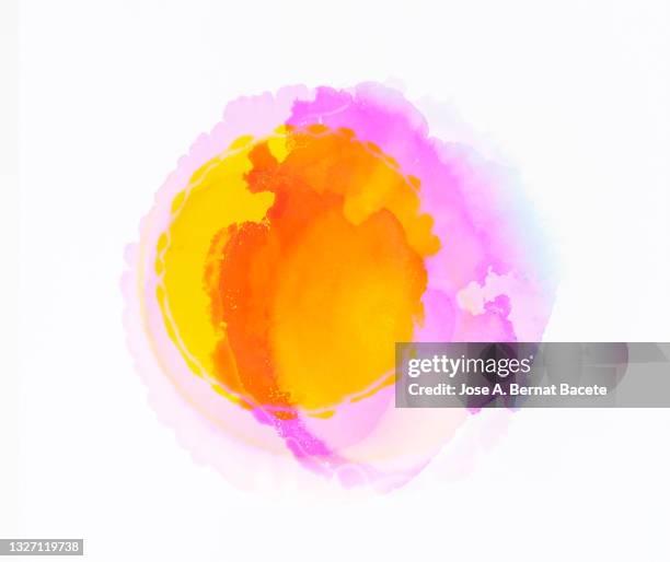 splashes of a drop of yellow and pink paint on a white canvas. - watercolor splash stock pictures, royalty-free photos & images