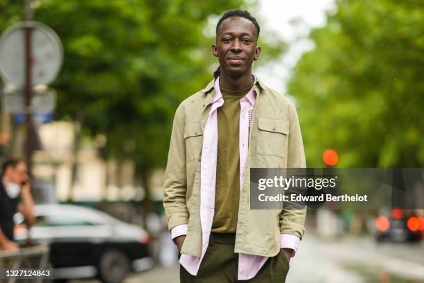 Guest wears a green t-shirt, a pale pink shirt, a khaki shirt, khaki pants, outside Off-White, as part of Paris Fashion Week Fall/Winter 2021/2022 on...