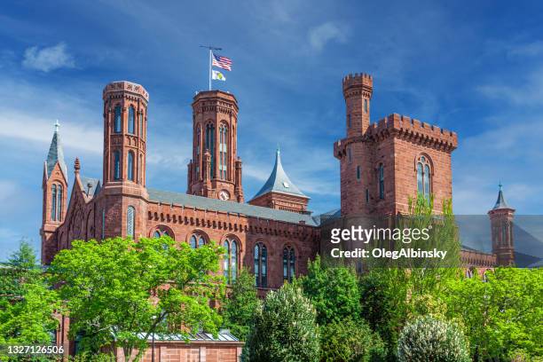 rear view of the smithsonian castle, smithsonian institution, with blue sky and clouds, washington dc. - smithsonian institute stockfoto's en -beelden