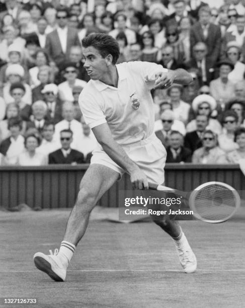 Manuel Santana of Spain plays a return to Ken Fletcher of Australia during their Men's Singles Quarter Final match at the Wimbledon Lawn Tennis...