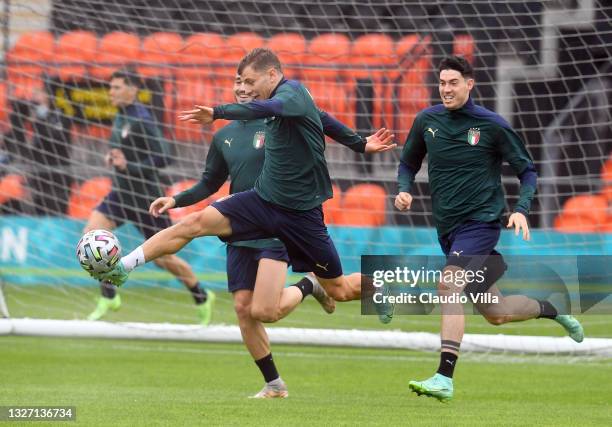 Nicolo Barella of Italy runs with the ball ahead of Alessandro Bastoni during the Italy training session ahead of the Euro 2020 Semi-Final match...