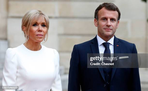 French President Emmanuel Macron and his wife Brigitte Macron stand side-by-side prior to a state dinner with Italian President Sergio Mattarella and...