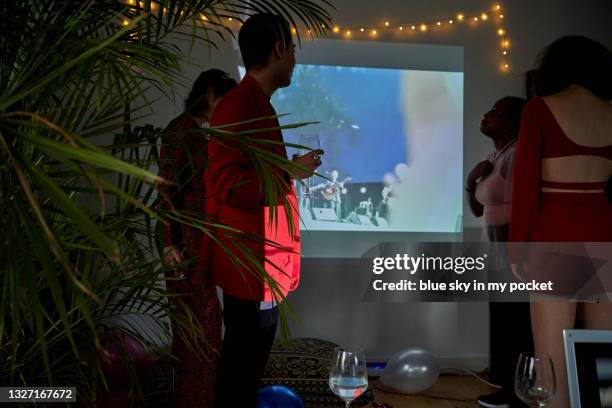 four people dancing at a music festival projector part virtual event - projection equipment stock pictures, royalty-free photos & images