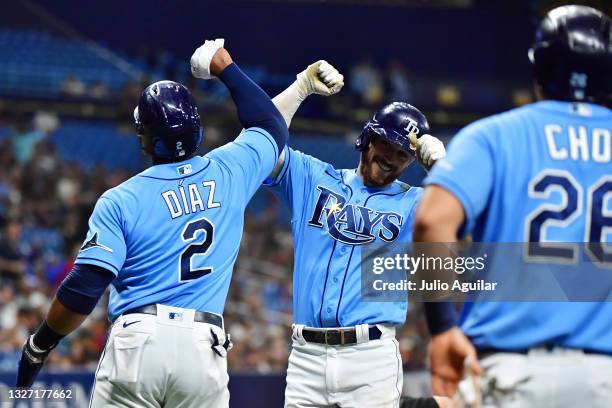 Brandon Lowe of the Tampa Bay Rays celebrates his grand slam home run off of Logan Allen of the Cleveland Indians with Yandy Diaz in the second...