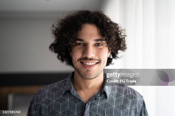 portrait of a happy young man at home - moustaches stock pictures, royalty-free photos & images