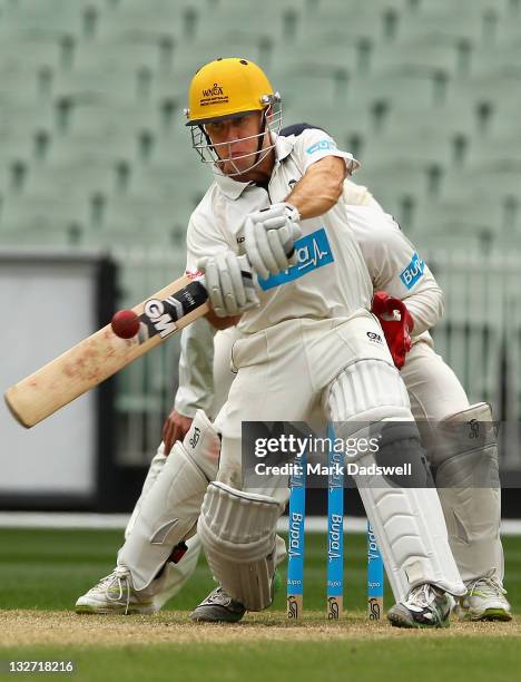 Liam Davis of the Warriors smashes a short ball to the boundary during day four of the Sheffield Shield match between the Victoria Bushrangers and...