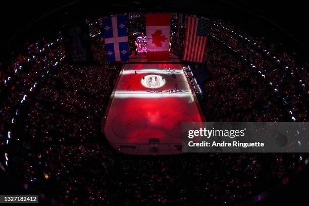 The Montreal Canadiens and the Tampa Bay Lightning stand on the ice during a moment of silence for Columbus Blue Jackets goalie Matiss Kivlenieks...