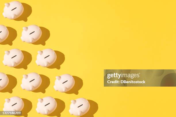 little pink ceramic piggy bank pattern on the left side on yellow background. concept of saving money, savings. - money saving stock-fotos und bilder