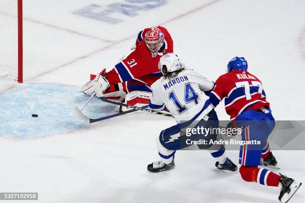 Pat Maroon of the Tampa Bay Lightning scores the tying goal past Carey Price of the Montreal Canadiens as Brett Kulak defends during the third period...