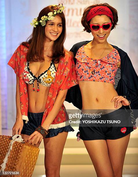 Models display the latest swimwear during Japanese apparel maker San-ai's 2012 collection in Tokyo on November 14, 2011. Japanese apparel maker...