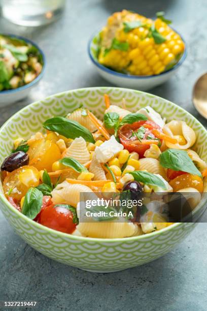 pasta salad olives tomatoes goat cheese - pasta salad stock pictures, royalty-free photos & images