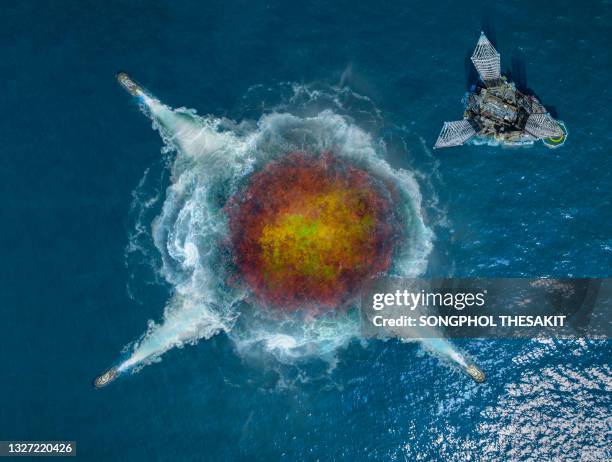 aerial view/sea gas leak causes fire in undersea near drilling rig - gulf of mexico oil rig stockfoto's en -beelden