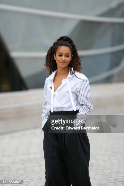 Lena Mahfouf "Lena Situations" wears a white ripped ruffled oversized shirt with black stripes on the sleeves and fringed on the collar, black large...