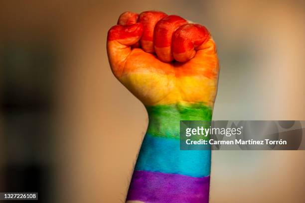 lgbtq2 happy pride month raised fist with rainbow colors. - the love parade stock pictures, royalty-free photos & images